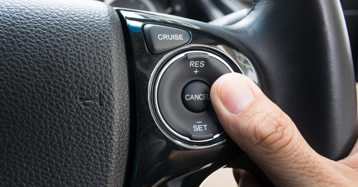 hand pushes cruise control buttons