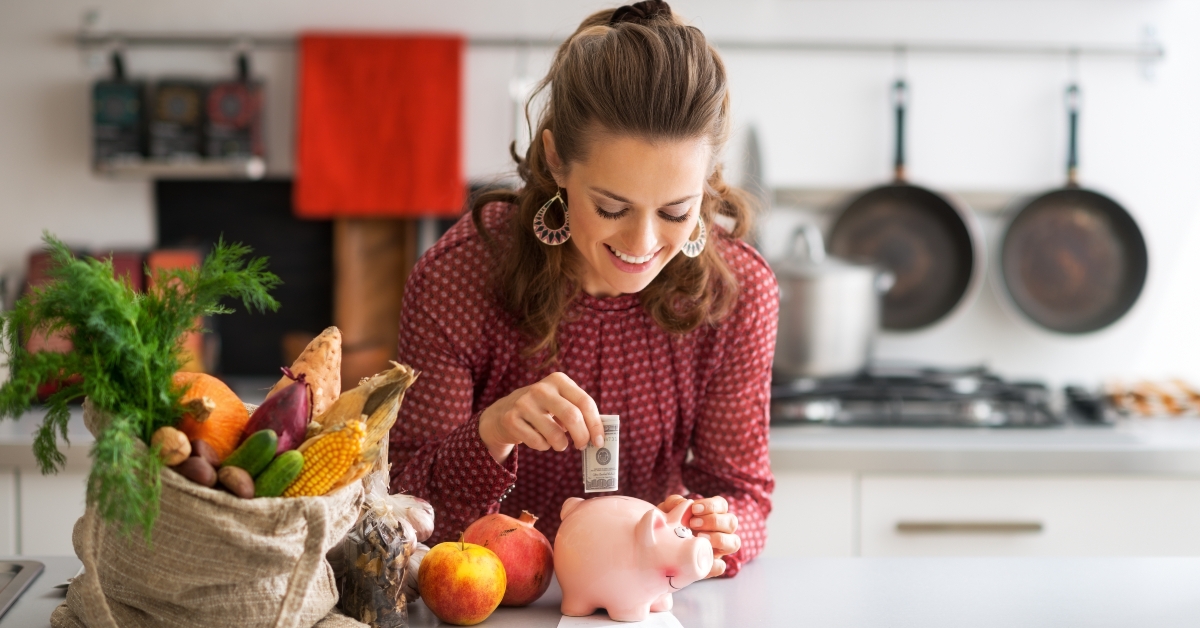 housewife putting money into piggy bank