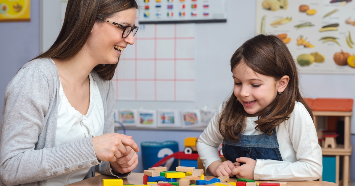 Preschool teacher with cute girl
