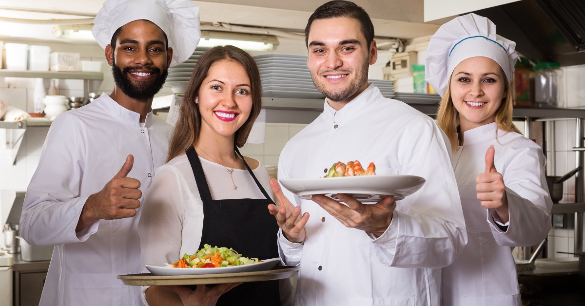 Professional cooks posing at restaurant