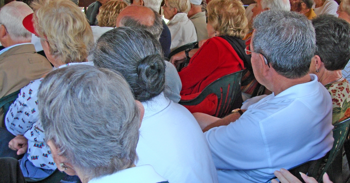 senior audience attending outdoor community event