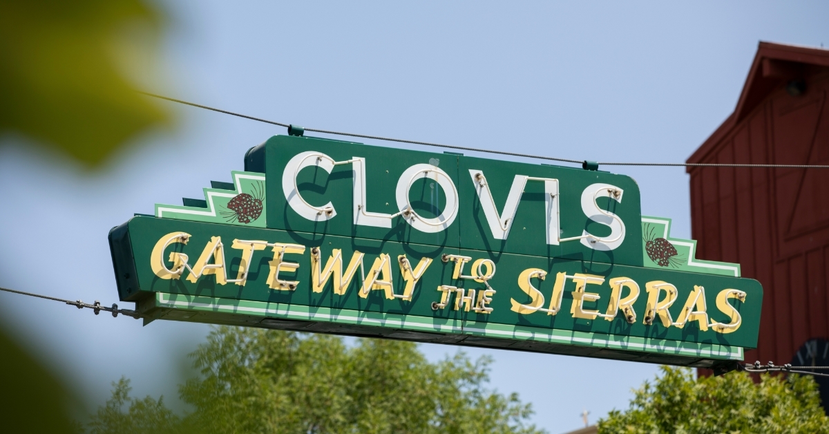 Clovis neon sign hanging over street