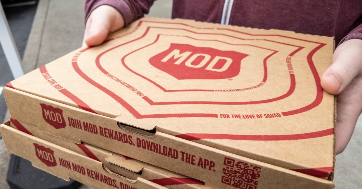 man holding boxes from Mod Pizza 