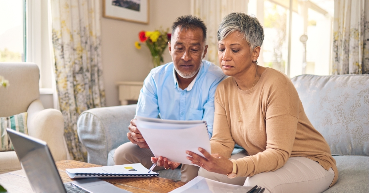 frsutrated senior couple reviewing bills 