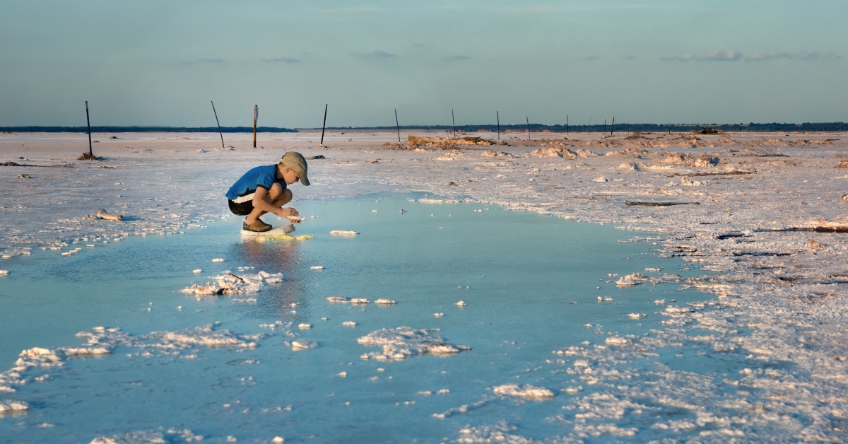 boy collects salt crystals