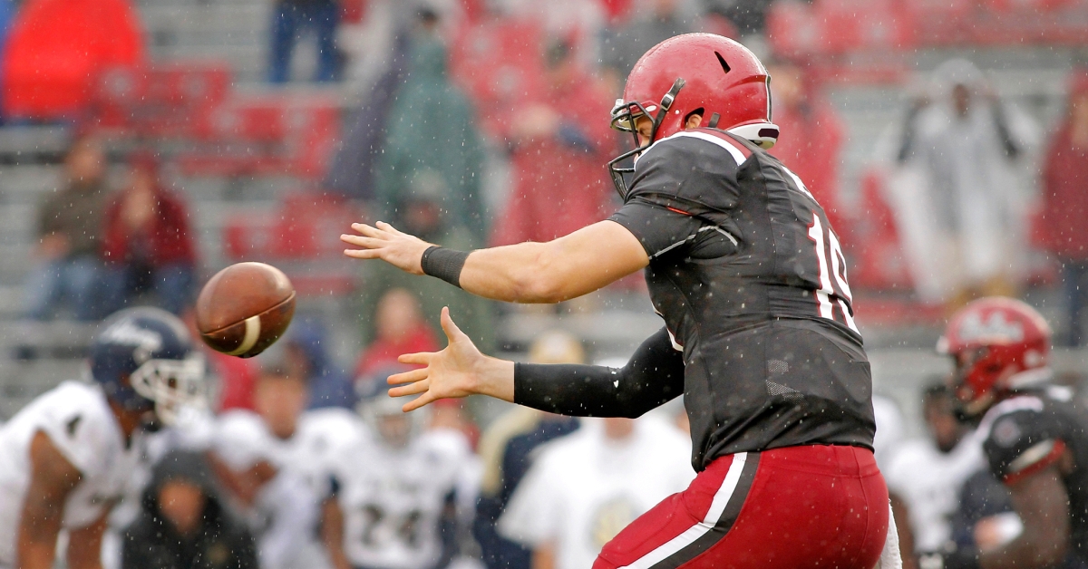 American football quarterback taking a snap
