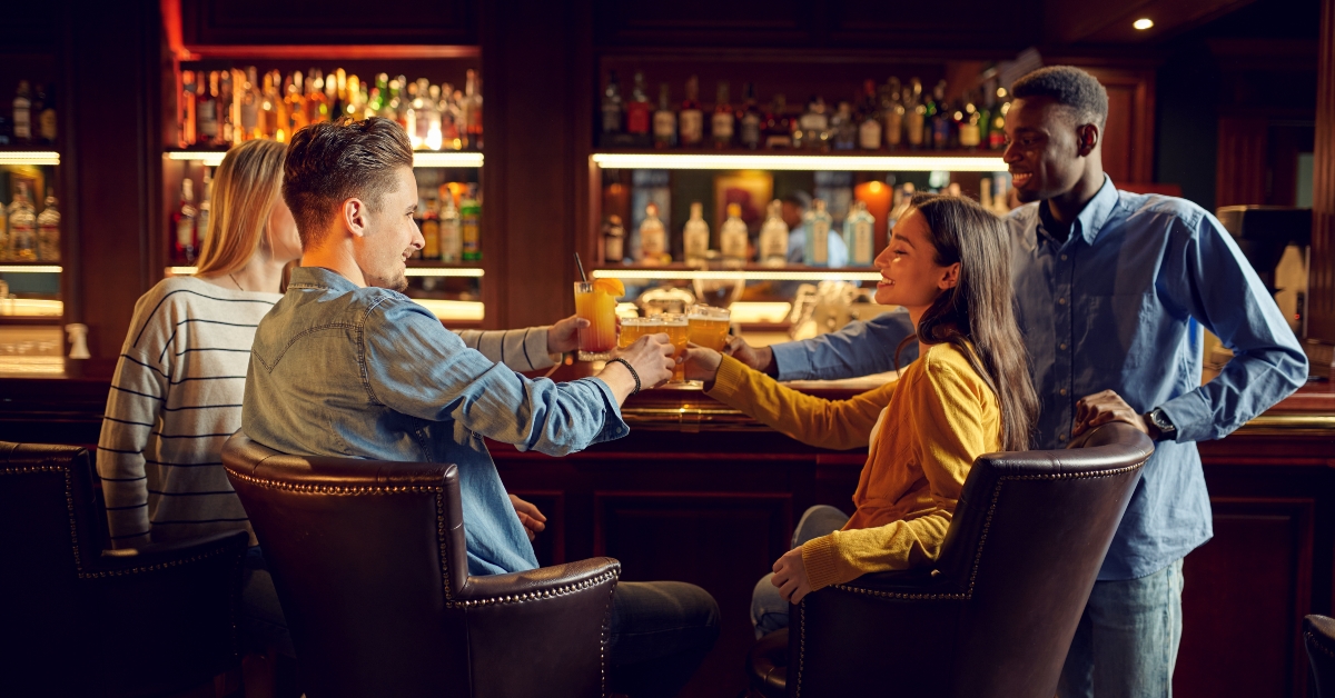 Cheerful friends drinks beer
