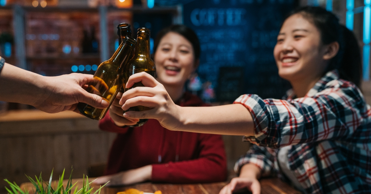 Happy friends drinking and toasting