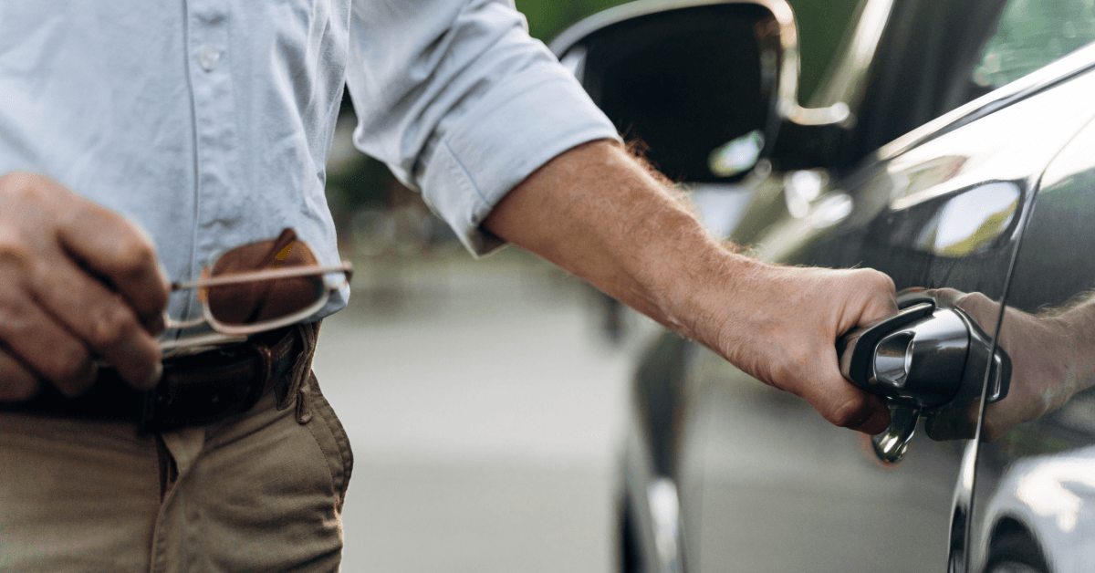 Senior man opens the door of his car