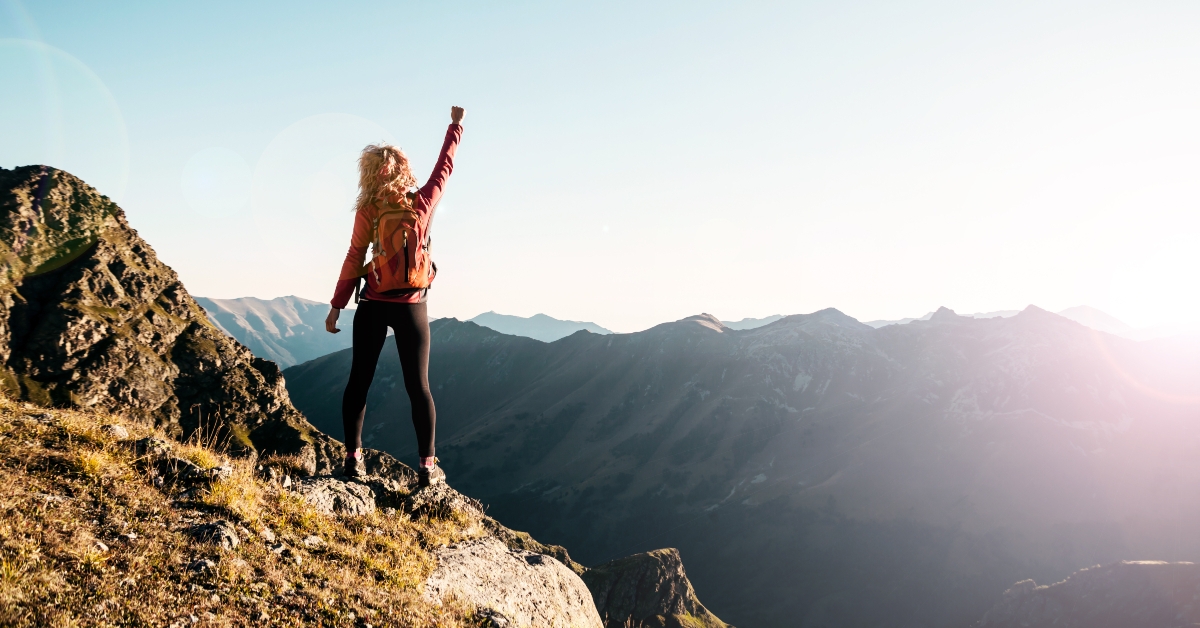 woman on the top in the mountains