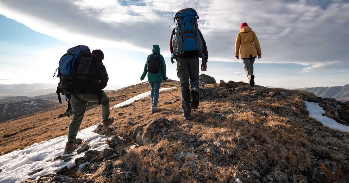 hikers walks on mountain top