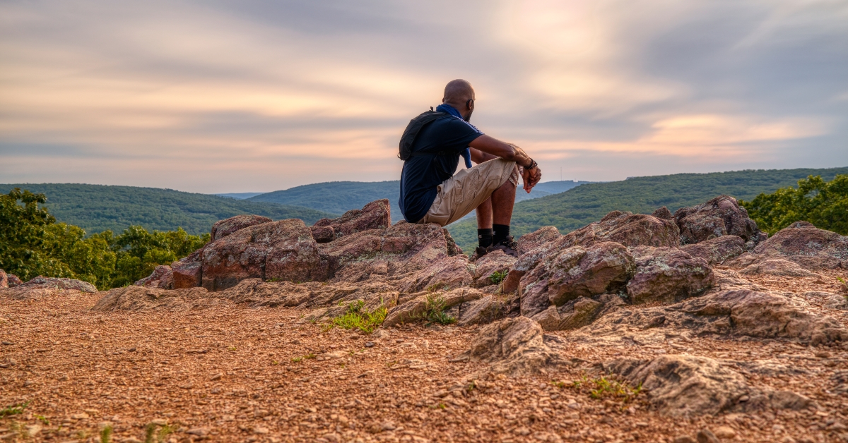 man at the top of a mountain