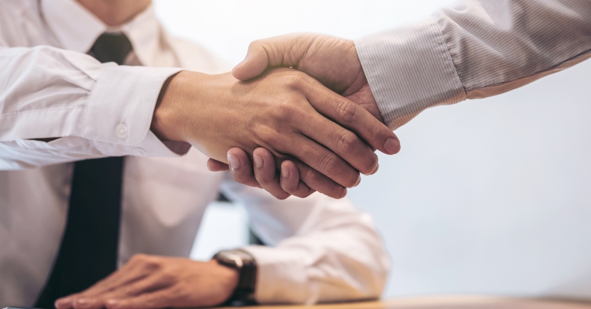 Estate agent shaking hands with customer 
