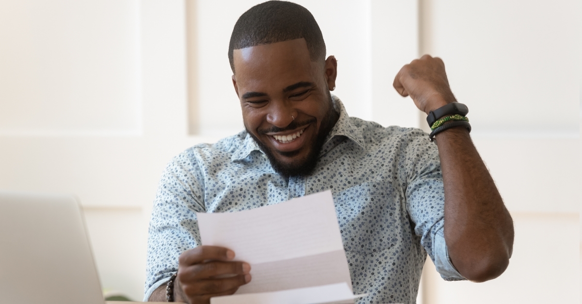Happy african american guy receiving loan