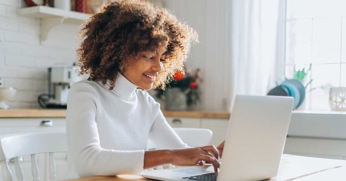 african american woman shopping online using laptop