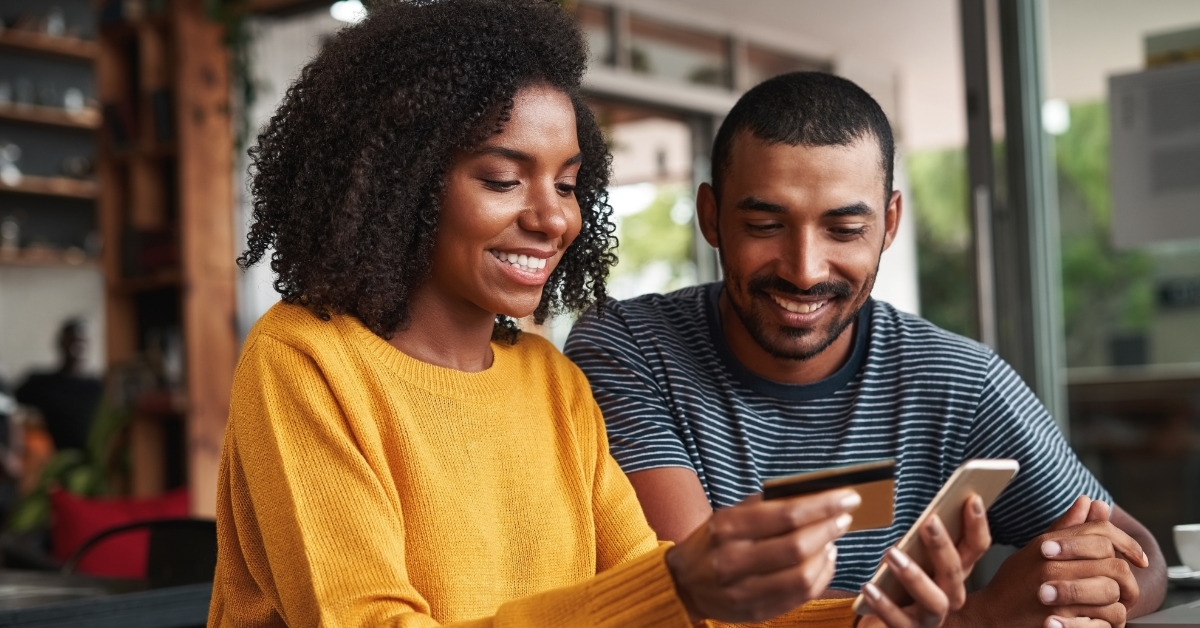 couple shopping online at cafe