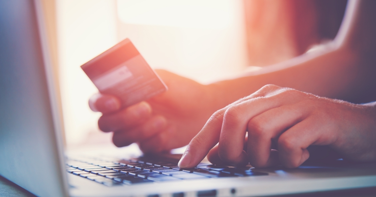 hand holding card using laptop for shopping