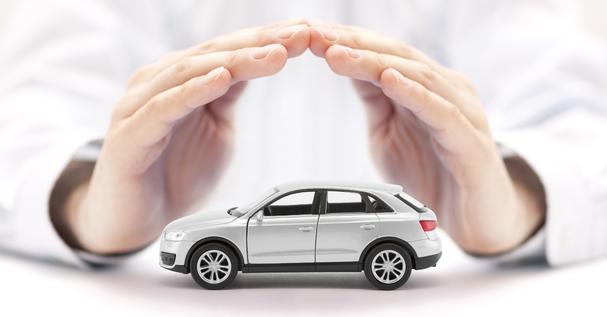small silver car covered by hands