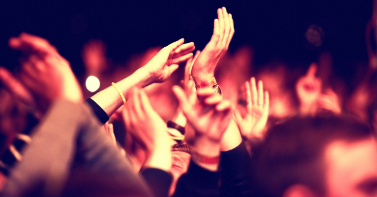 audience with hands raised