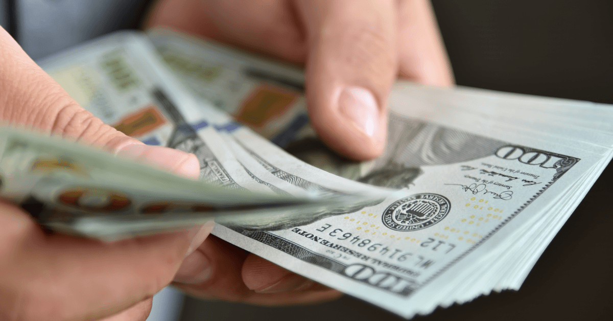 Close up of businessman counting money in hands