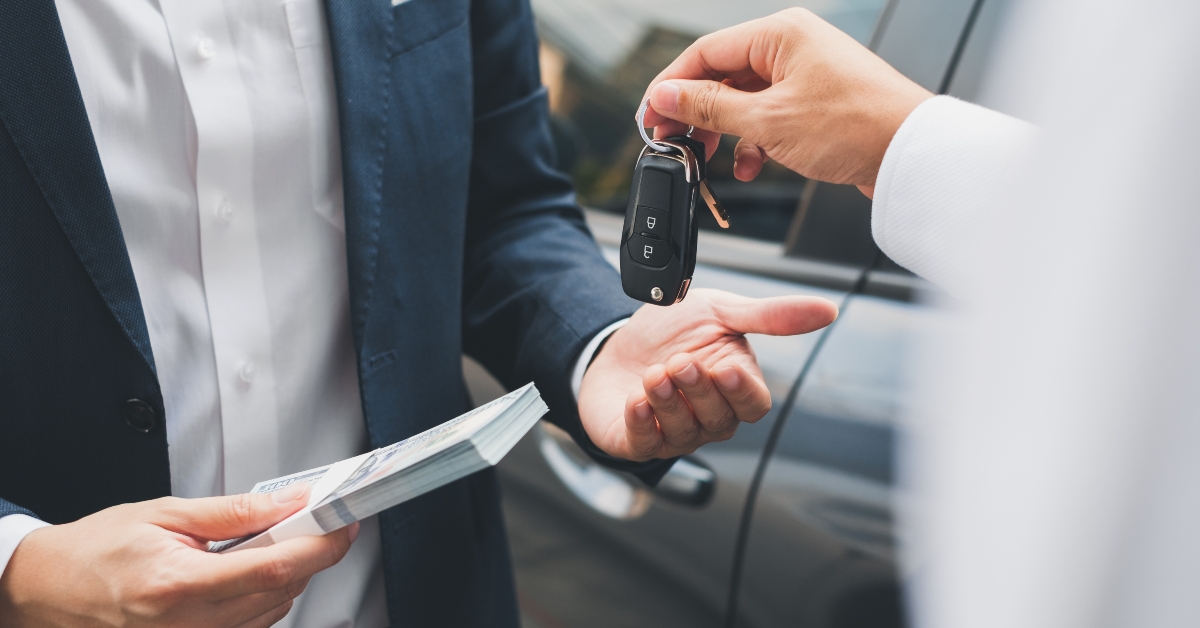 hand giving a car key