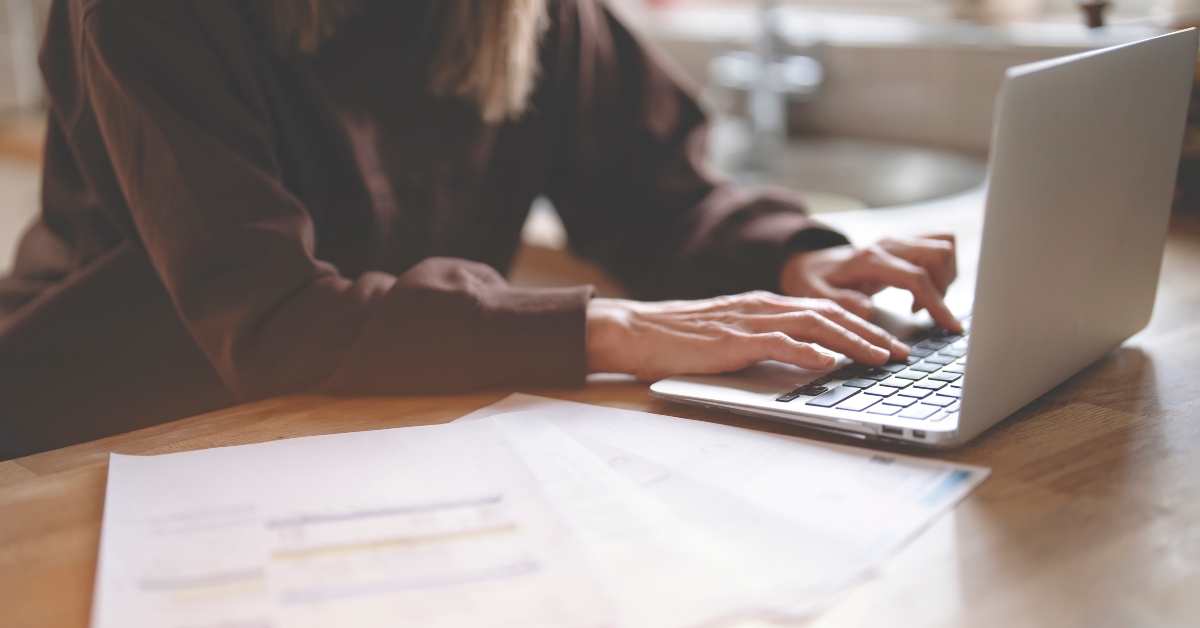 Hands of woman using laptop