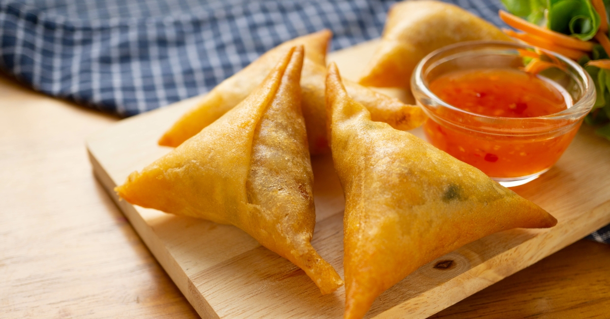 samosas on wooden board.