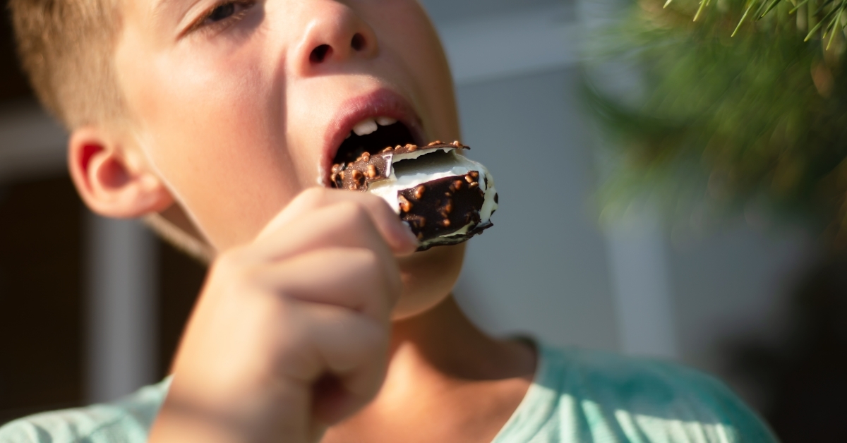 boy eating chocolate nuts ice cream 