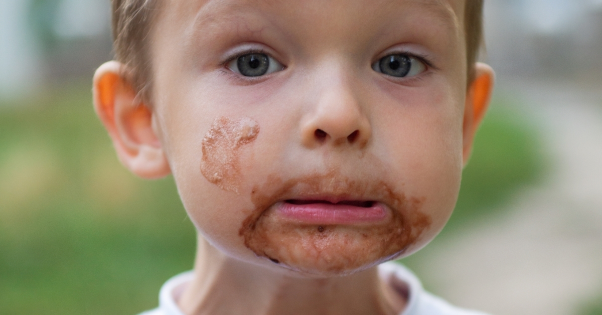 Cute boy with ice cream on face