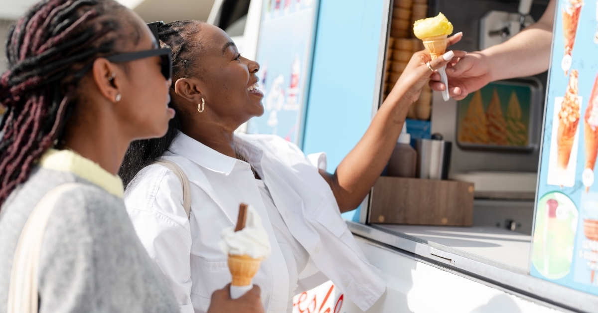 female friends buying ice cream from truck