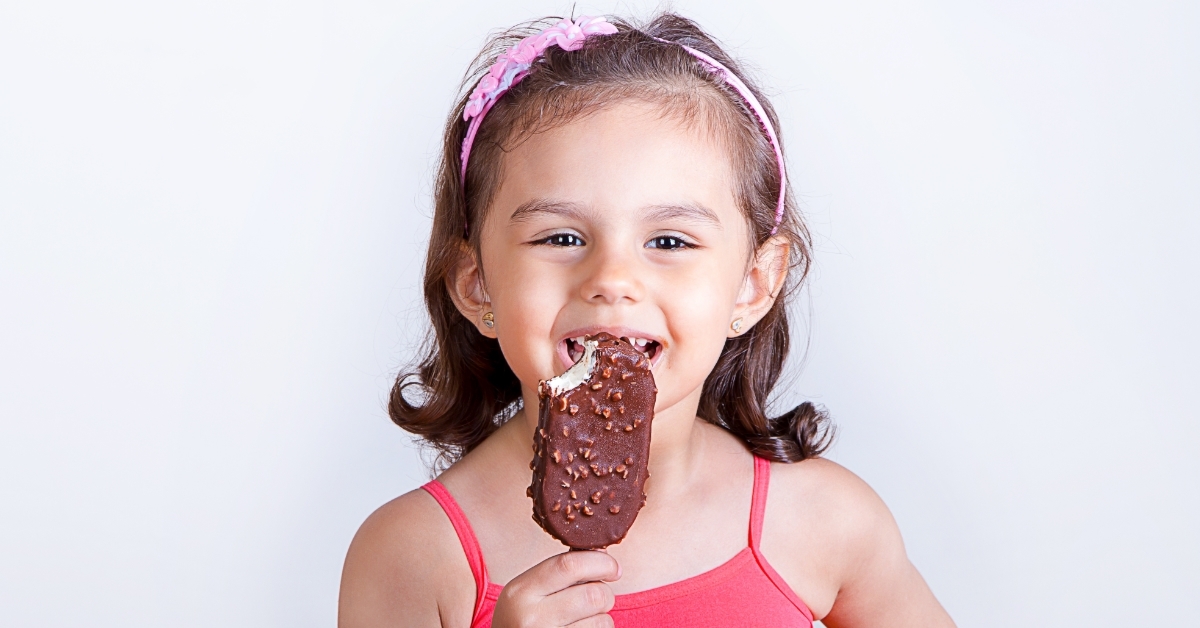 happy girl eating ice cream bar