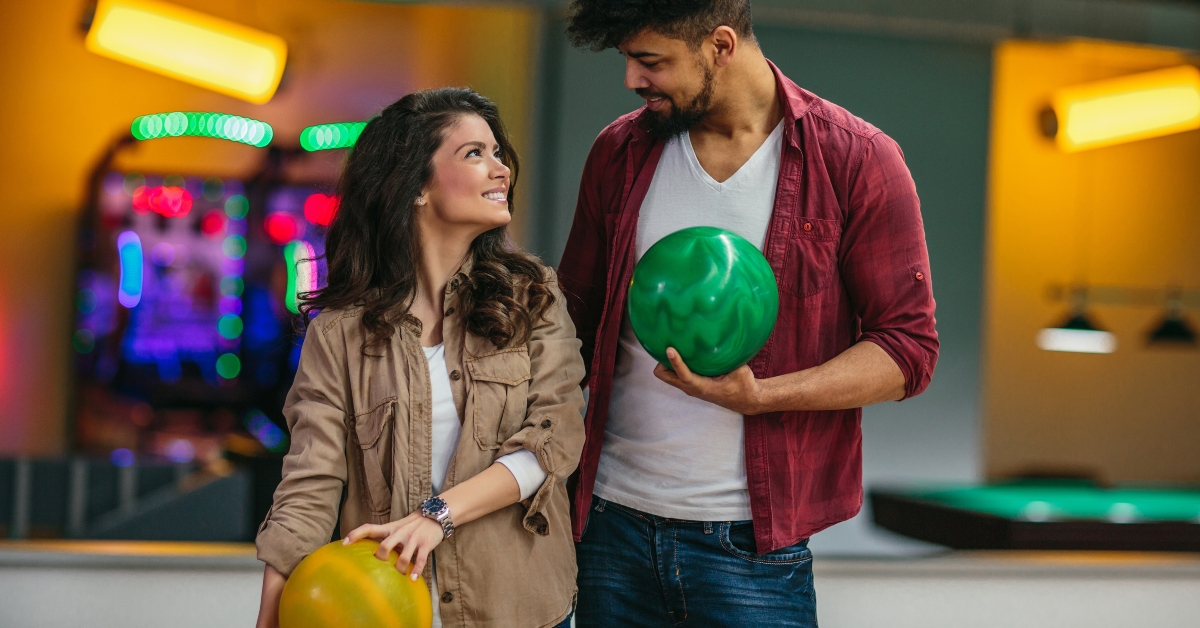 couple holding bowling balls