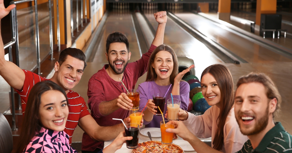 friends with drinks and pizza