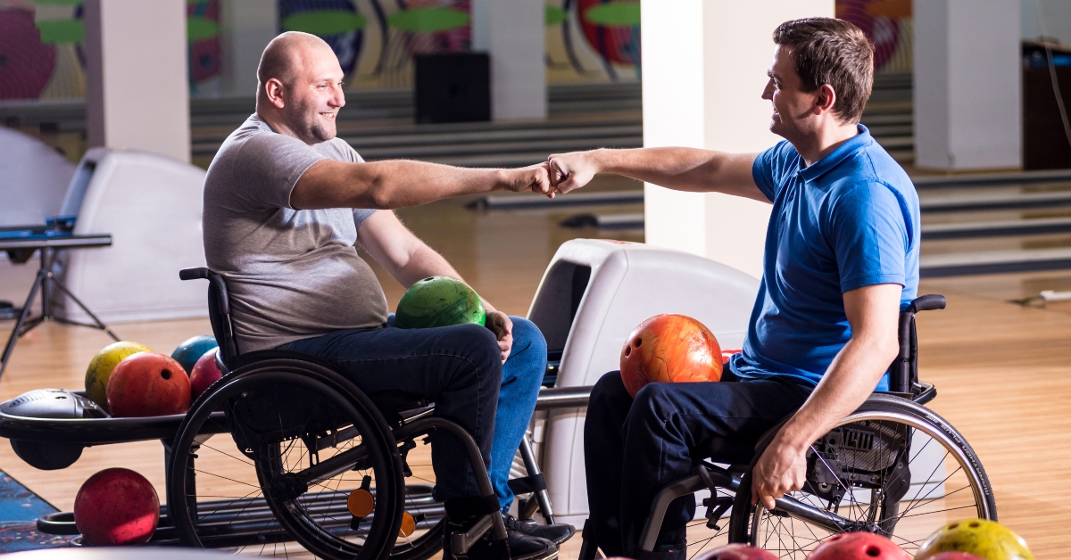 men in wheelchairs playing bowling