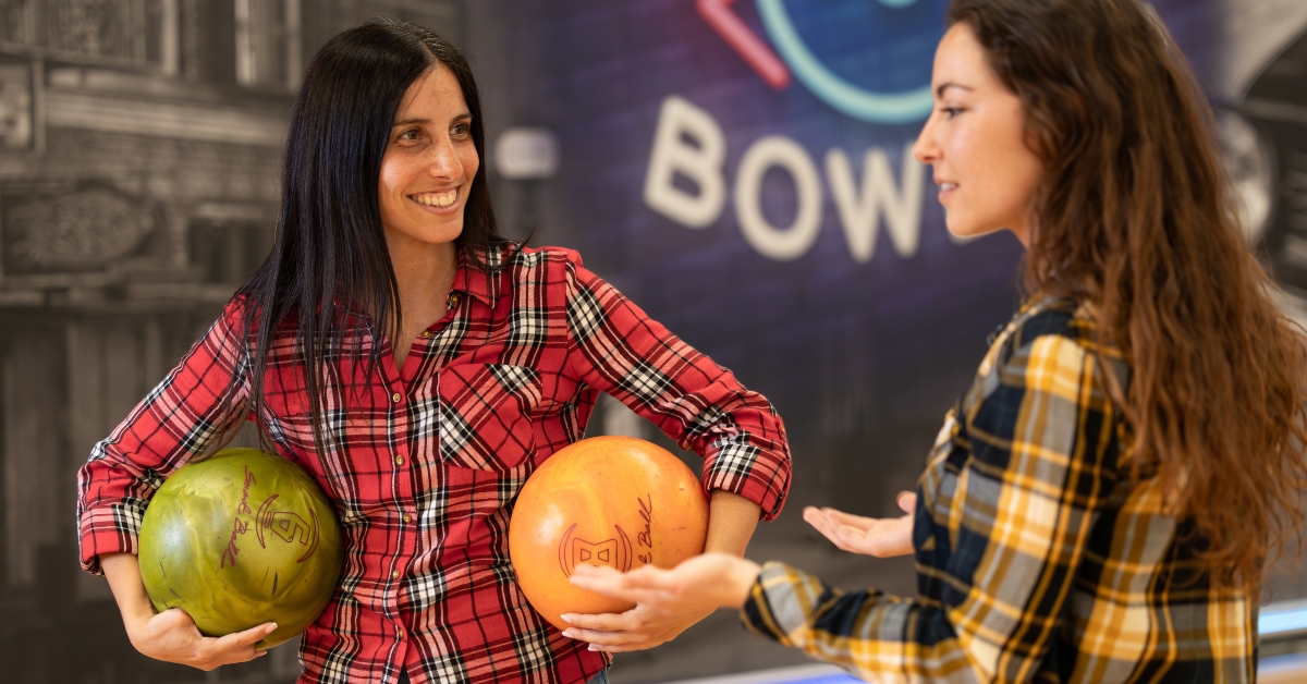 women playing bowling