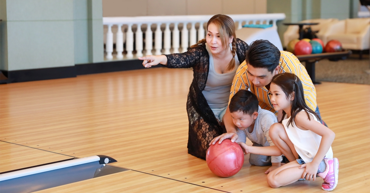 family playing bowling