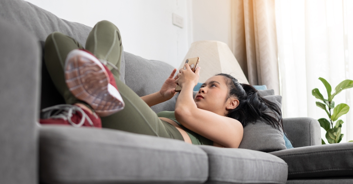 woman lying with smartphone