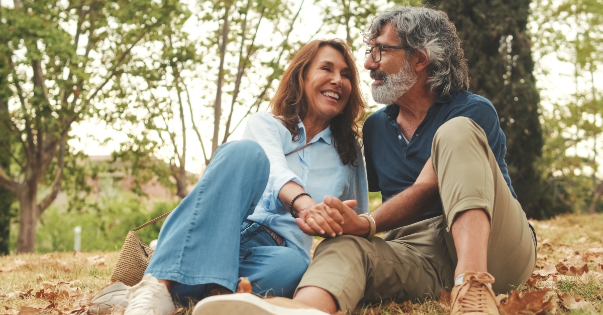 retired couple sitting on the grass