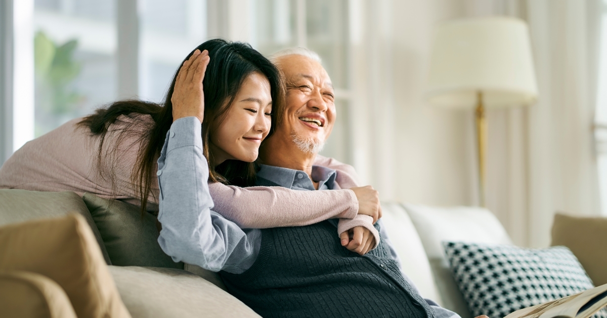 happy asian daughter hugging father at home