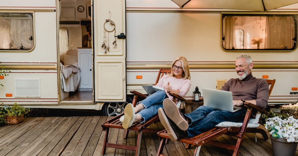 senior couple enjoying vacation on camper van