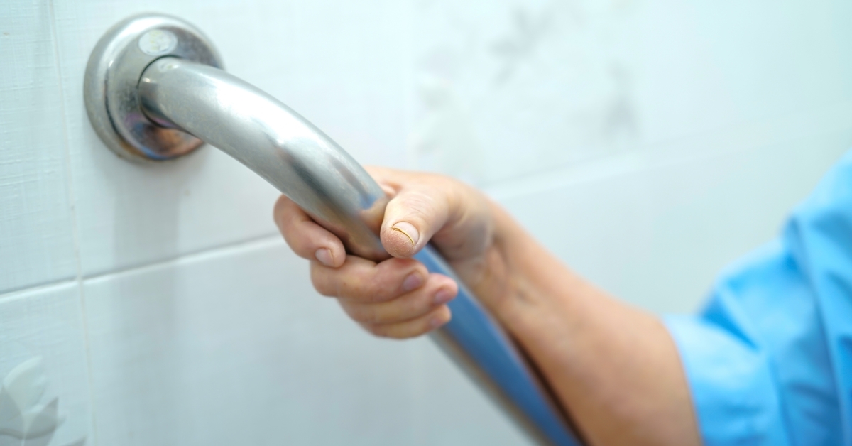 senior woman using security handle at hospital