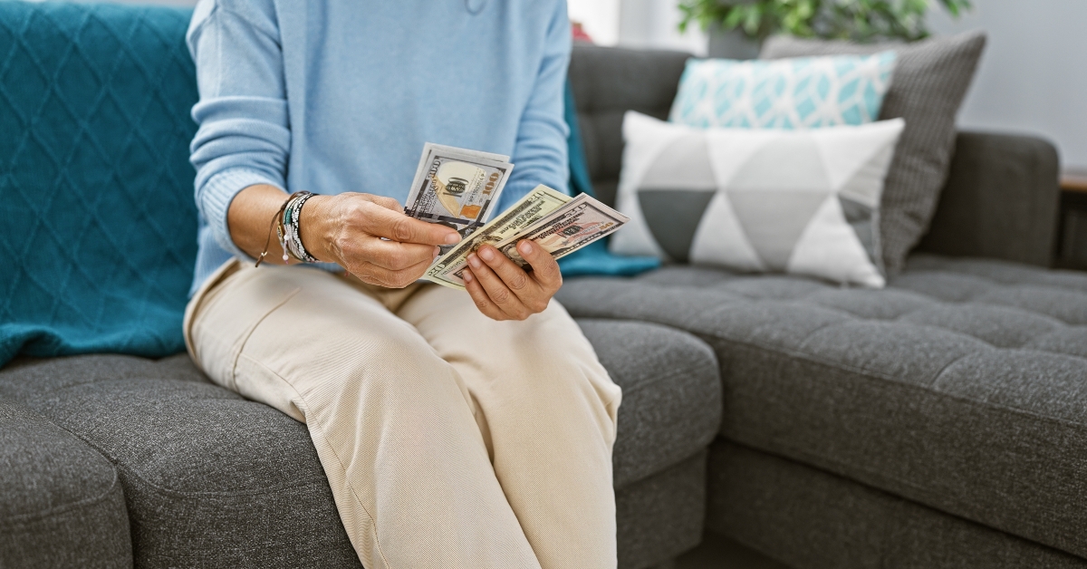 Woman counts us dollars sitting