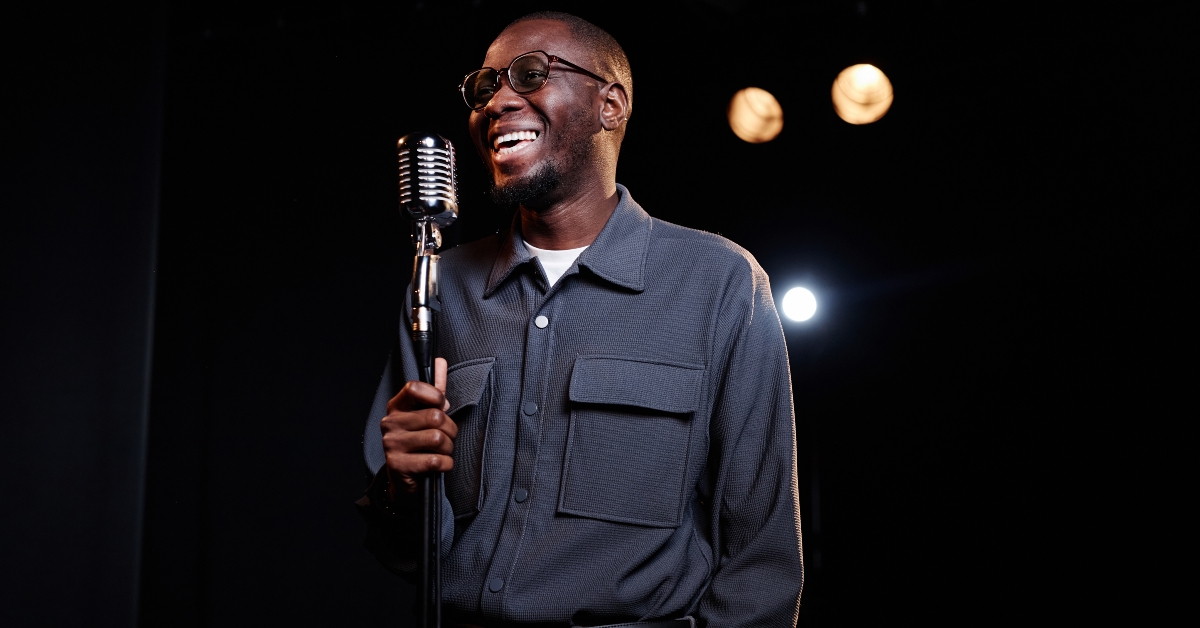 Black man speaking to microphone