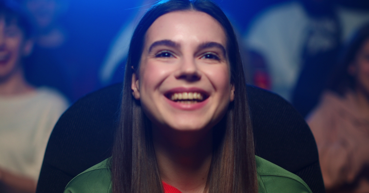 Happy woman watching funny film