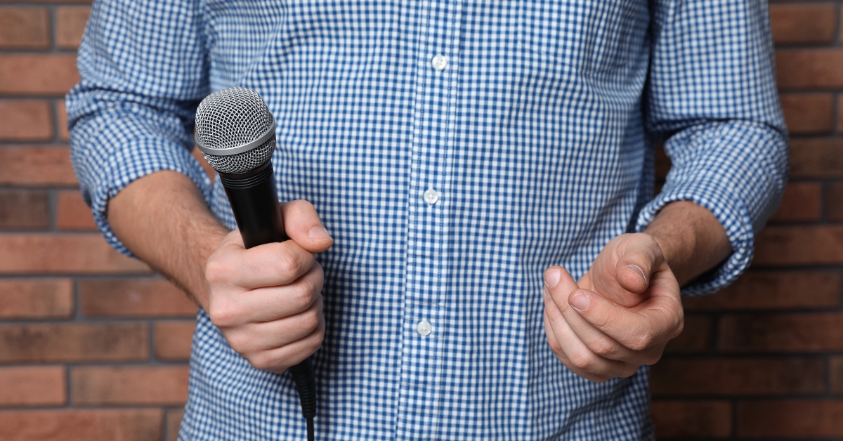 Man in shirt holding microphone