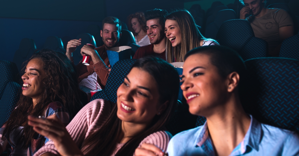 People laughing while watching movie