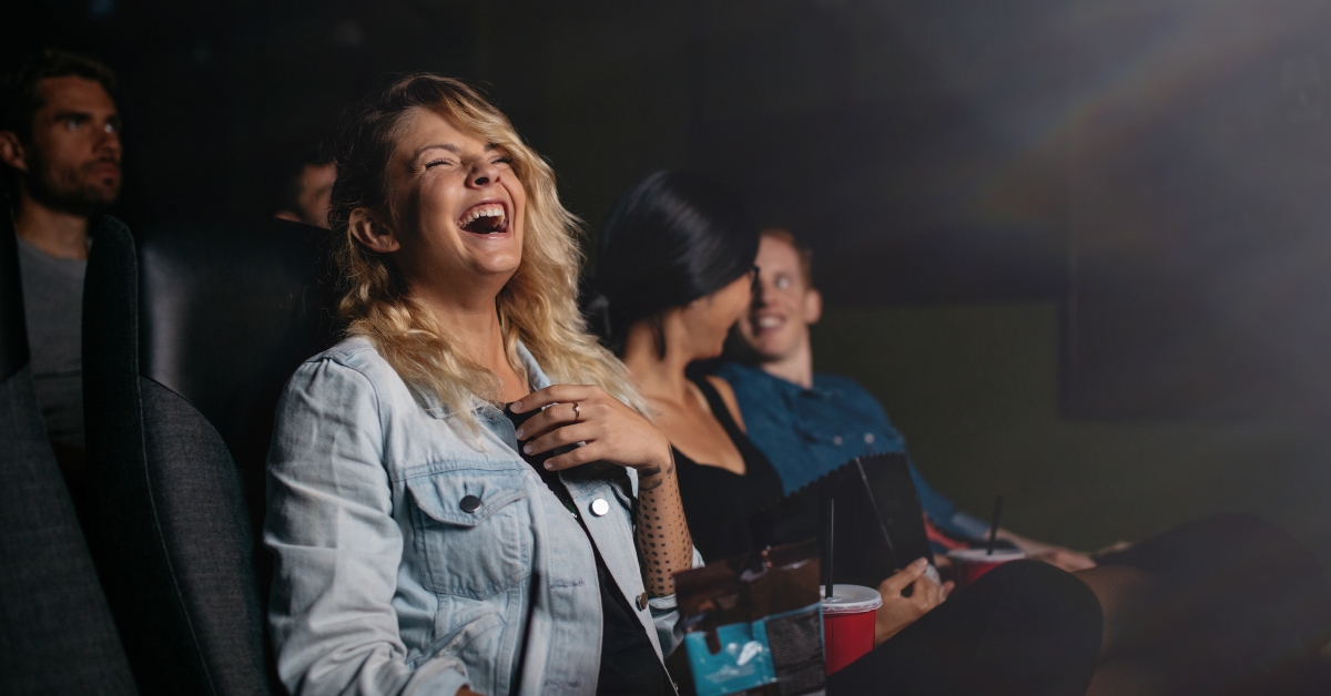 People watching movie and laughing