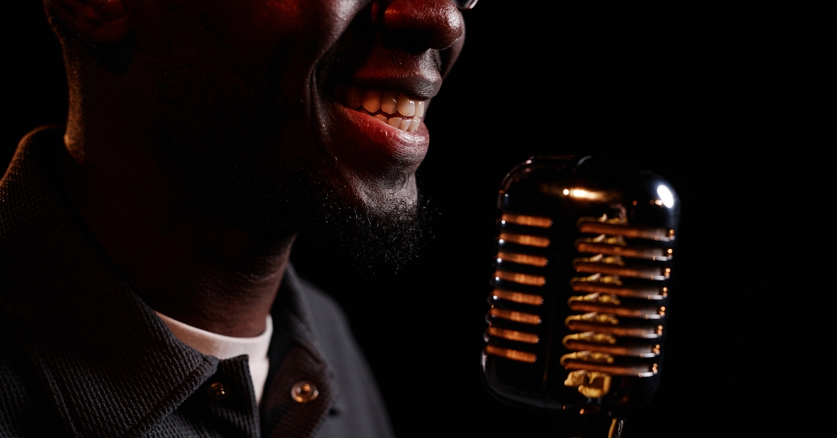 Smiling man speaking to microphone