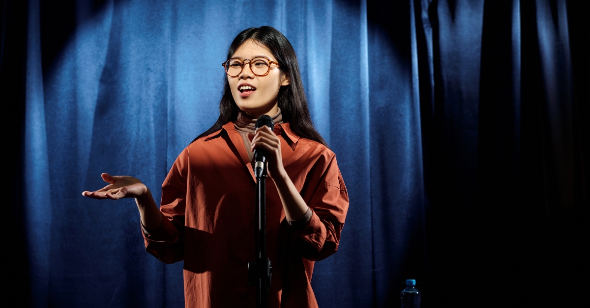 Young comedian in eyeglasses