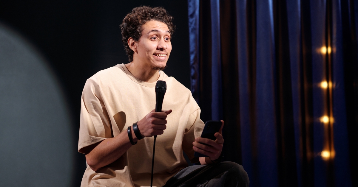 Young comedian with microphone